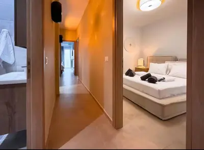 a bedroom with a bed and a sink and a mirror at Elegant VIP Apartment - Athens Town in Athens