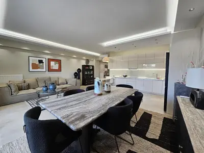 a kitchen and living room with a large table and chairs at Elegant VIP Apartment - Athens Town in Athens
