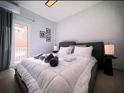 a large white bed with towels on it in a bedroom at Elegant VIP Apartment - Athens Town in Athens