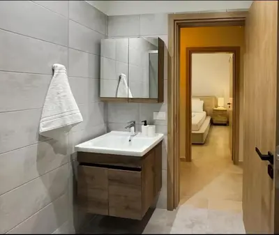 a bathroom with a sink and a mirror at Elegant VIP Apartment - Athens Town in Athens