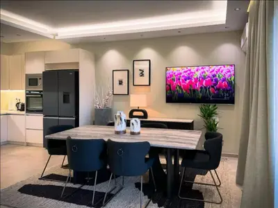 a kitchen and dining room with a table and chairs at Elegant VIP Apartment - Athens Town in Athens
