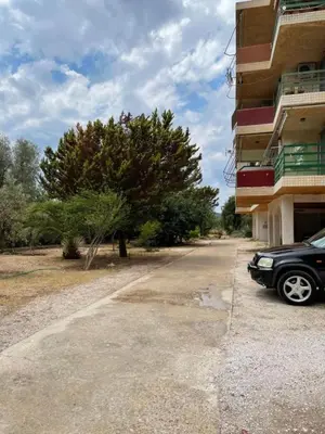 a car parked in a parking lot next to a building at lemonsky apartment in Palaiá Fókaia