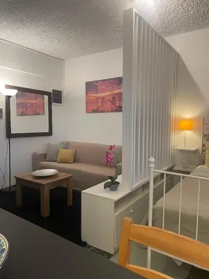 a living room with a couch and a table at lemonsky apartment in Palaiá Fókaia