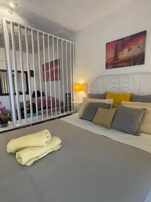 a bedroom with a bed and a blanket on the floor at lemonsky apartment in Palaiá Fókaia