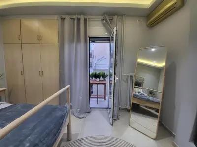 a small room with a bed and a mirror at Glory Apartment 3is septemvriou in Athens