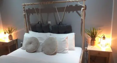 a bedroom with a bed with two lamps and two pillows at Glory Apartment 3is septemvriou in Athens