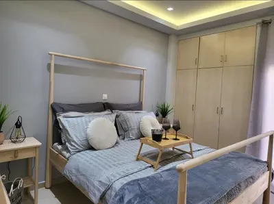 a bedroom with a bed with a table on it at Glory Apartment 3is septemvriou in Athens