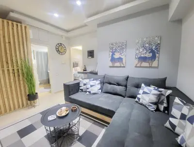 a living room with a couch and a table at Glory Apartment 3is septemvriou in Athens