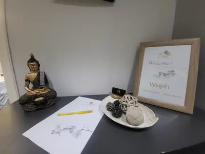 a table with a sign and a statue and a plate at Glory Apartment 3is septemvriou in Athens