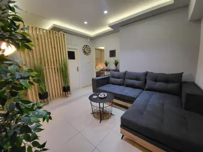 a living room with a couch and a table at Glory Apartment 3is septemvriou in Athens
