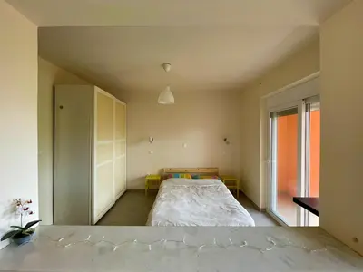 a bedroom with a bed and a large window at Argithea View in Papangeláki