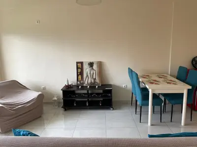 a room with a table and a table and chairs at Argithea View in Papangeláki