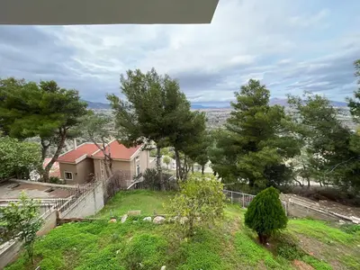 a house with a yard with trees and a fence at Argithea View in Papangeláki