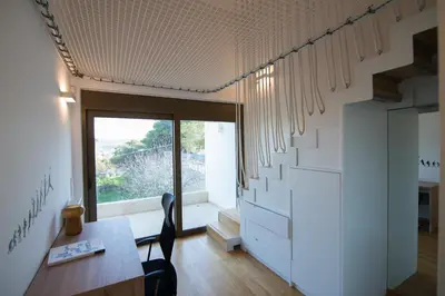 a living room with a table and a staircase at Amuse Athens Villa in Vari