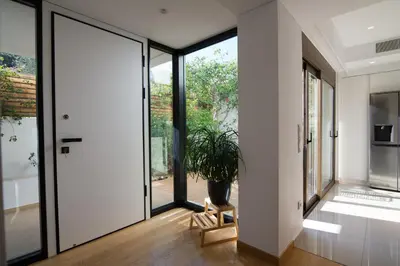a hallway with a door and a potted plant at Amuse Athens Villa in Vari