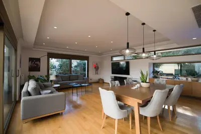 a dining room and living room with a table and chairs at Amuse Athens Villa in Vari