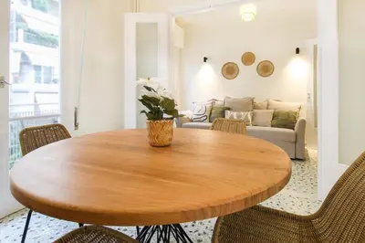 a wooden table in a living room with a couch at Stylish and cosy apartment near the Acropolis in Athens