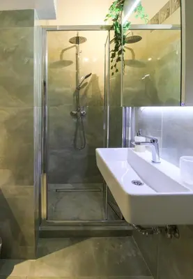 a bathroom with a sink and a shower at Stylish and cosy apartment near the Acropolis in Athens