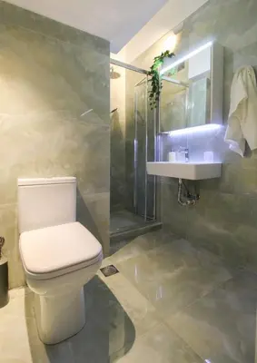 a bathroom with a toilet and a sink and a shower at Stylish and cosy apartment near the Acropolis in Athens