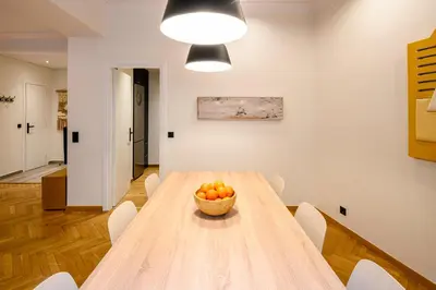 a dining room with a wooden table with a bowl of fruit at Plaka Premier Stay - Steps from Acropolis Museum and Metro in Athens