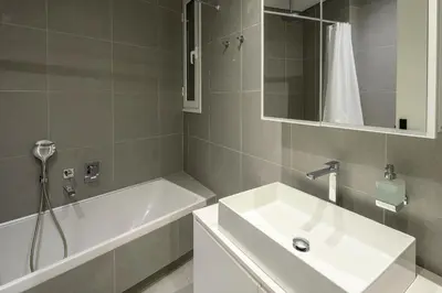 a bathroom with a sink and a bath tub at Plaka Premier Stay - Steps from Acropolis Museum and Metro in Athens