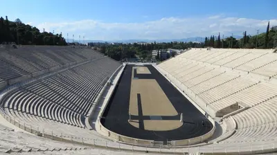 an empty stadium with a tennis court in it at Plaka Premier Stay - Steps from Acropolis Museum and Metro in Athens