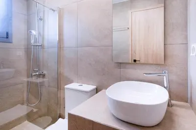 a bathroom with a toilet and a shower and a sink at M&H and their friends 1 in Athens