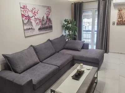a living room with a couch and a coffee table at 70m 2BR bright luxury apt in Athens