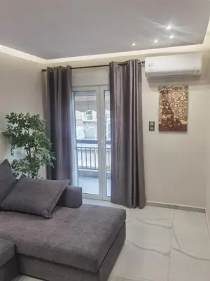 a living room with a couch and a window at 70m 2BR bright luxury apt in Athens