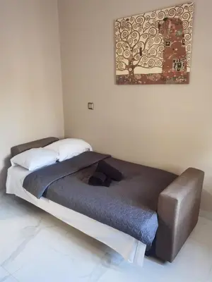 a bed in a room with a picture on the wall at 70m 2BR bright luxury apt in Athens