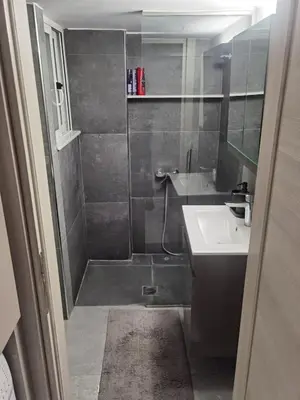 a small bathroom with a shower and a sink at 70m 2BR bright luxury apt in Athens