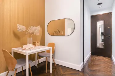 a room with a table and chairs and a mirror at Athens Heart Gem Lux Apartment in Athens