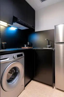 a kitchen with a washing machine and a washer at Athens Heart Gem Lux Apartment in Athens
