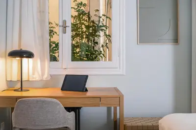 a desk in a room with a chair and a window at Athens Heart Gem Lux Apartment in Athens