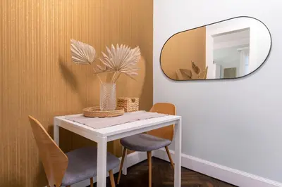 a table with two chairs and a mirror at Athens Heart Gem Lux Apartment in Athens