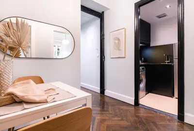 a living room with a table and a mirror at Athens Heart Gem Lux Apartment in Athens