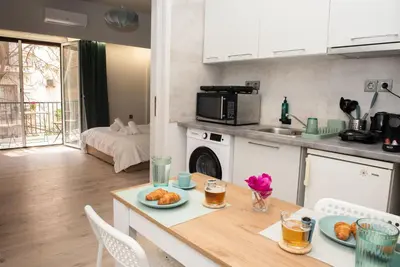 a kitchen with a table with a plate of food on it at Kolonaki Prime Location Luxurius Flat in Athens