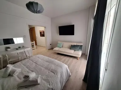a white bedroom with a bed and a couch at Kolonaki Prime Location Luxurius Flat in Athens