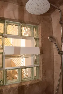 a bathroom with a window and a shower head at Kolonaki Prime Location Luxurius Flat in Athens