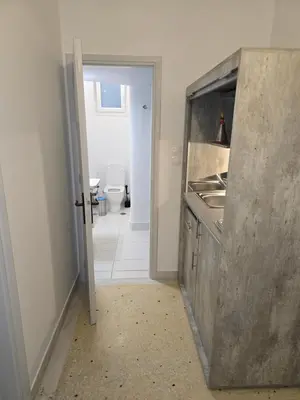 a kitchen with a sink and a counter top at Piraeus Metro Station in Piraeus