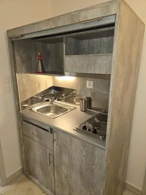 a stainless steel kitchen with a sink and a counter at Piraeus Metro Station in Piraeus
