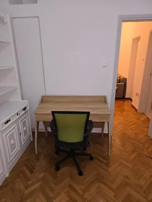 a desk with a green chair in a room at Piraeus Metro Station in Piraeus
