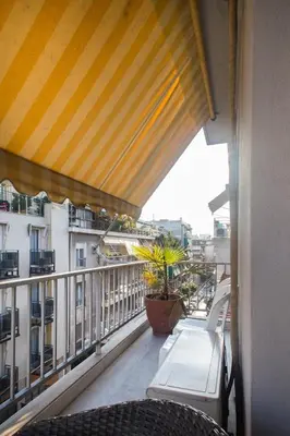 a balcony with chairs and a view of buildings at Acropolis Metro Station- Great Located Flat 125m2 in Athens