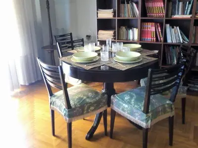 a black table with chairs and plates on it at Acropolis Metro Station- Great Located Flat 125m2 in Athens