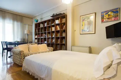 a bedroom with a bed and a book shelf at Acropolis Metro Station- Great Located Flat 125m2 in Athens