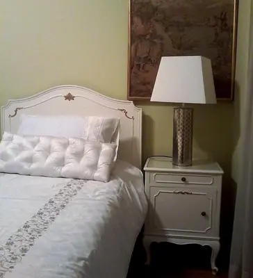 a bedroom with a bed and a lamp on a nightstand at Acropolis Metro Station- Great Located Flat 125m2 in Athens