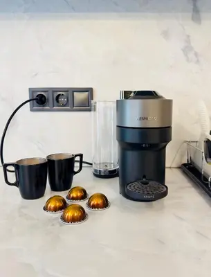 a coffee maker and some muffins on a counter at Modern Designer Home & Stylish Comfort Goudi in Athens
