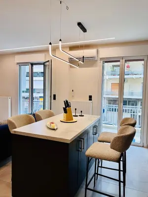 a kitchen with a large island with stools at Modern Designer Home & Stylish Comfort Goudi in Athens