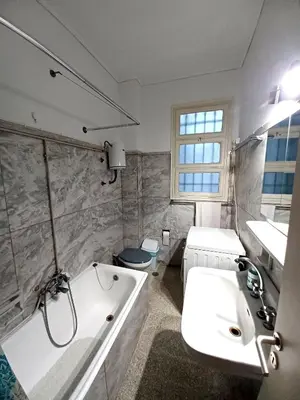 a white bathroom with a tub and a sink at Spacious Apartment 2 minutes from Omonoia Metro in Athens