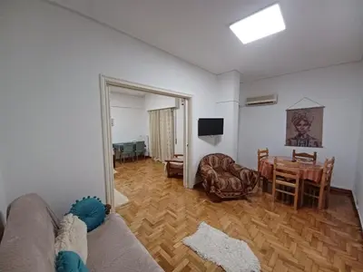 a living room with a couch and a table at Spacious Apartment 2 minutes from Omonoia Metro in Athens
